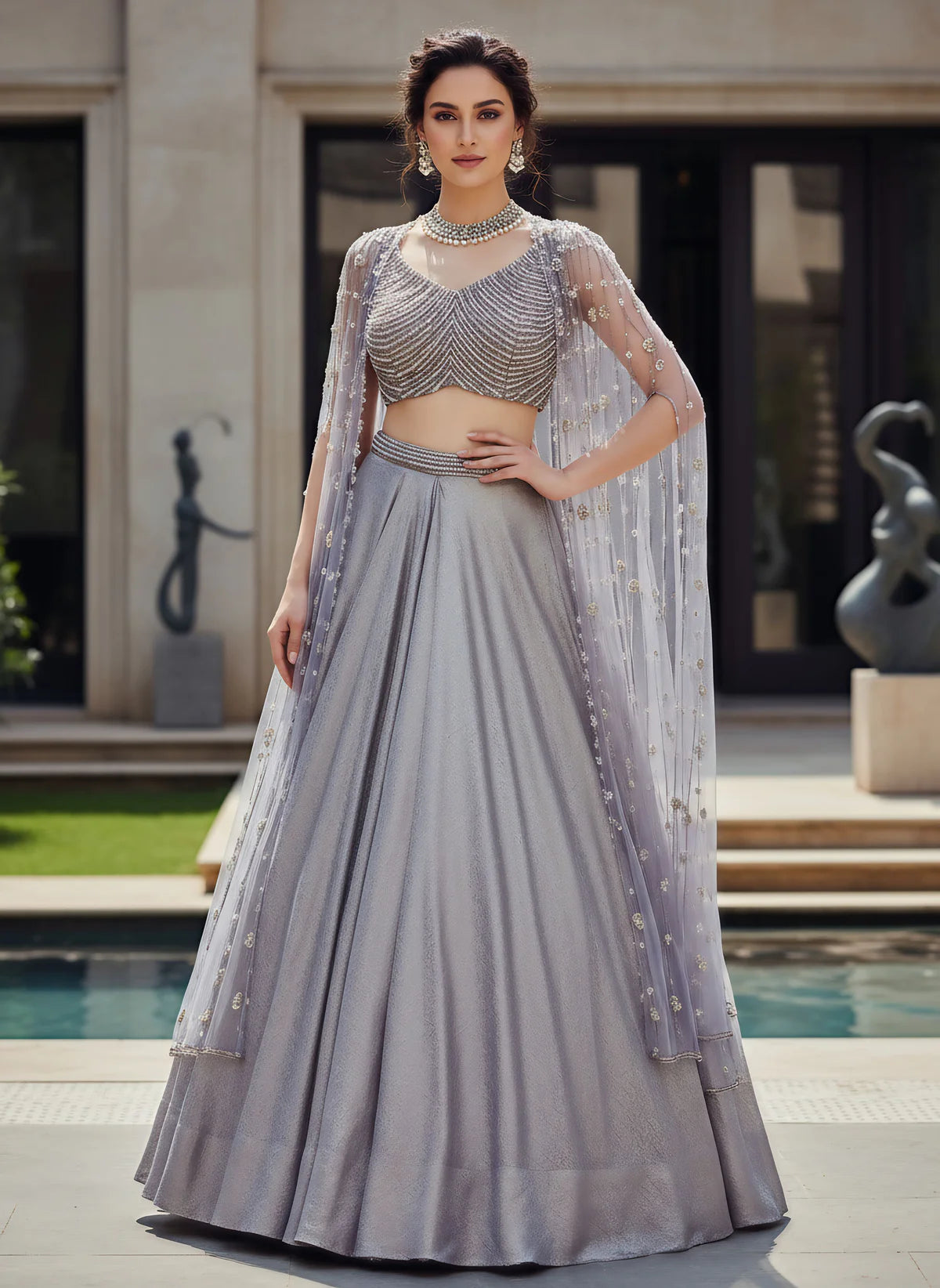 Silver Metallic Lehenga Set with Pearl Embellished Blouse and Net Cape