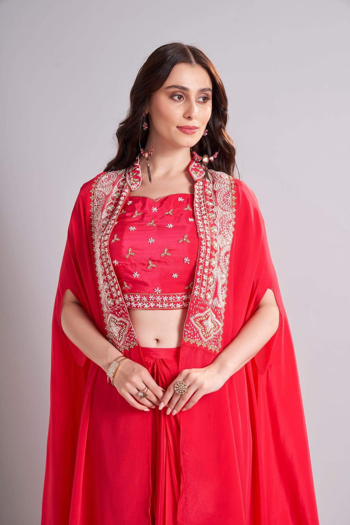 Radiant Red Draped Saree with Embroidered Crop Top & Cape Jacket – Designer Wedding & Festive Outfit