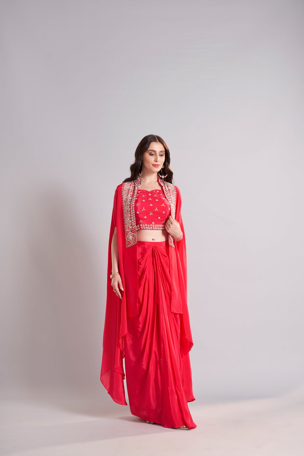 Radiant Red Draped Saree with Embroidered Crop Top & Cape Jacket – Designer Wedding & Festive Outfit