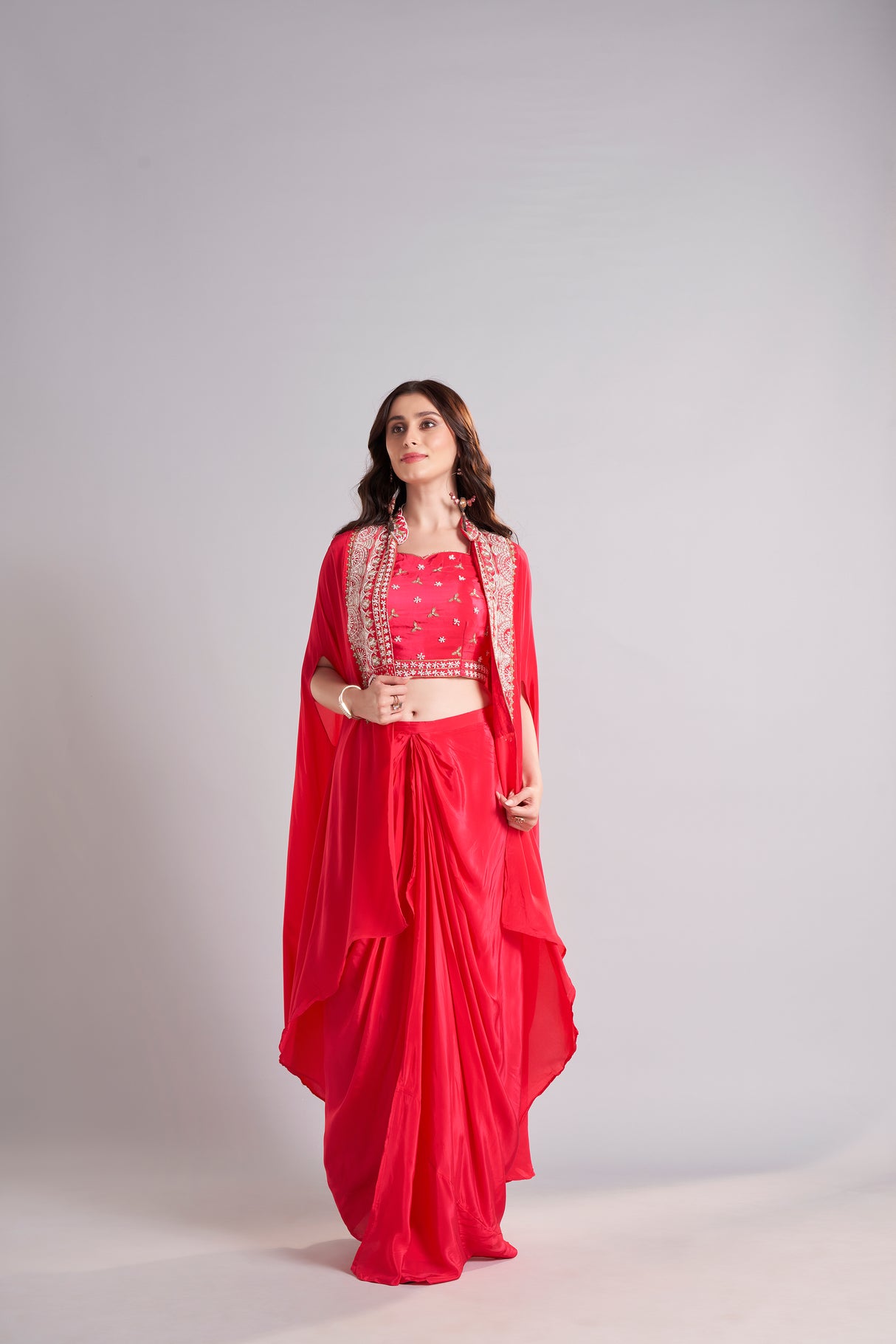 Radiant Red Draped Saree with Embroidered Crop Top & Cape Jacket – Designer Wedding & Festive Outfit