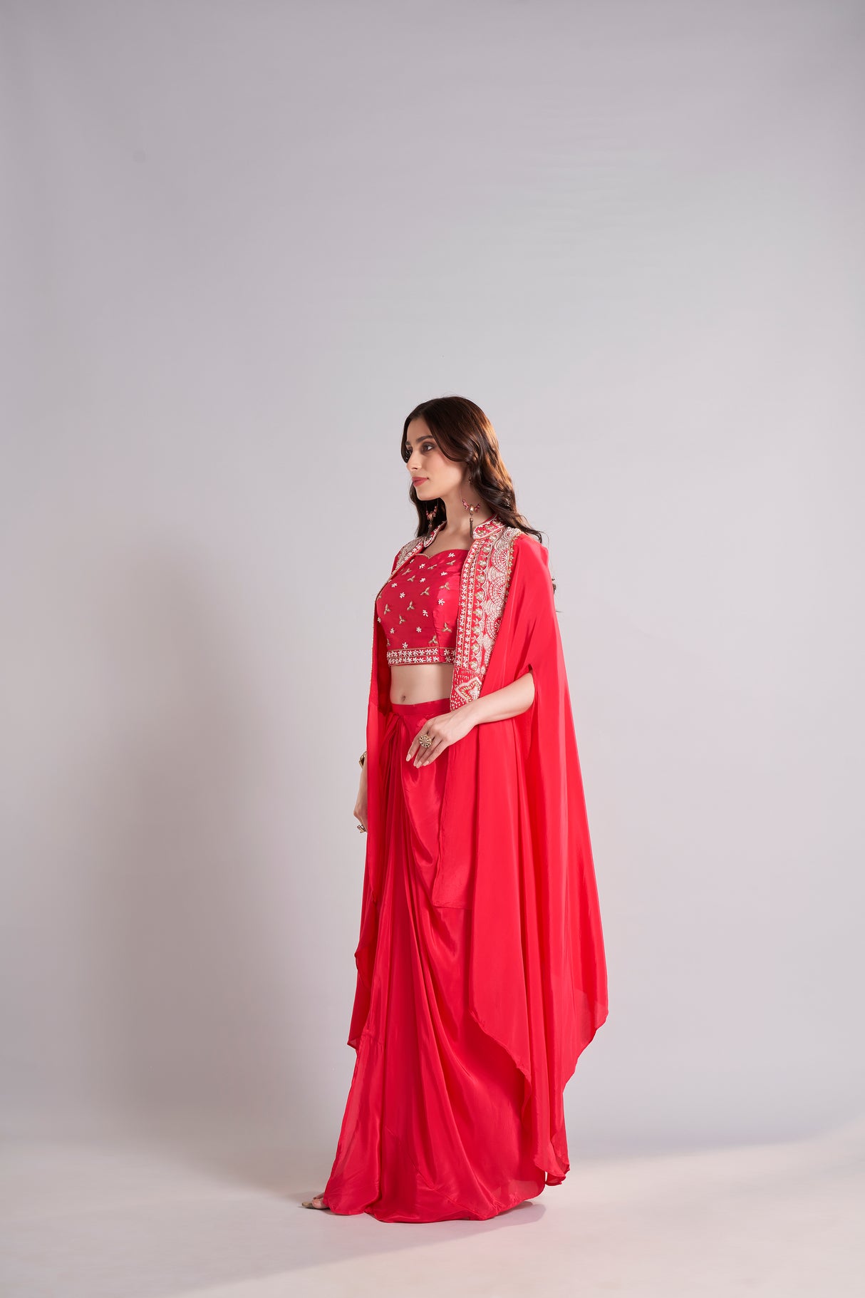 Radiant Red Draped Saree with Embroidered Crop Top & Cape Jacket – Designer Wedding & Festive Outfit