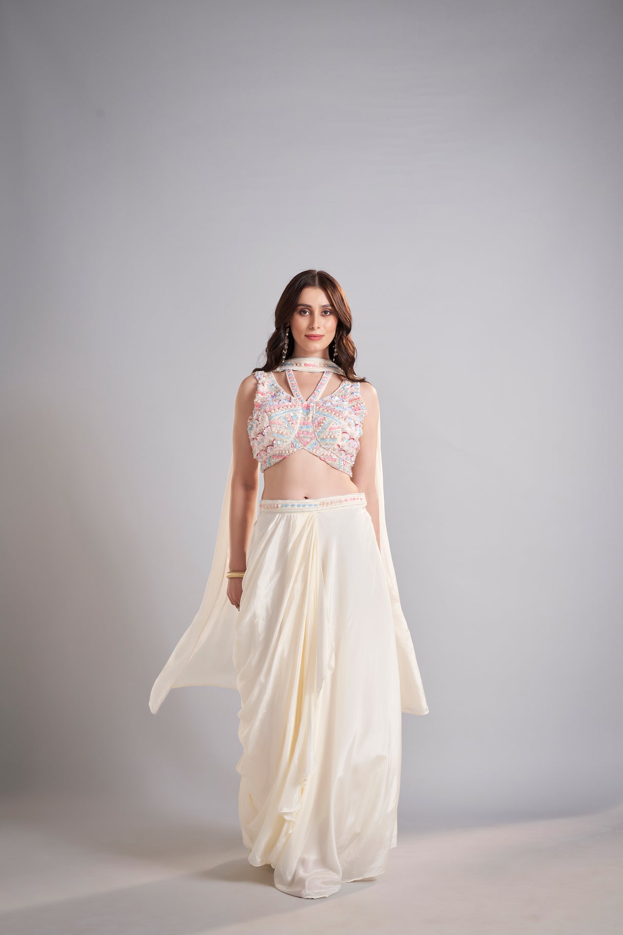 Ivory Draped Skirt with Pastel Embellished Crop Top & Flowing Drapes – Modern Wedding Reception Outfit