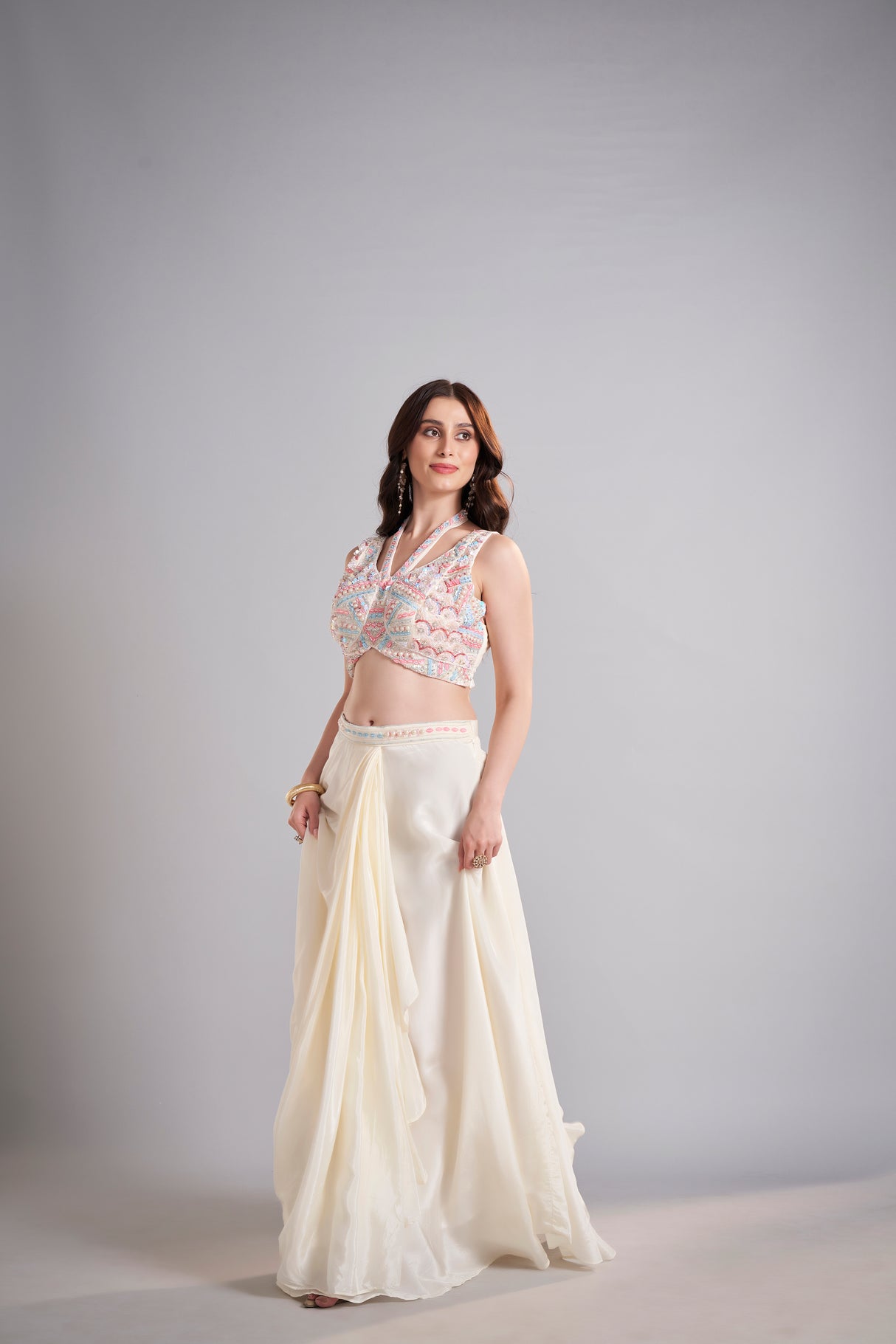 Ivory Draped Skirt with Pastel Embellished Crop Top & Flowing Drapes – Modern Wedding Reception Outfit