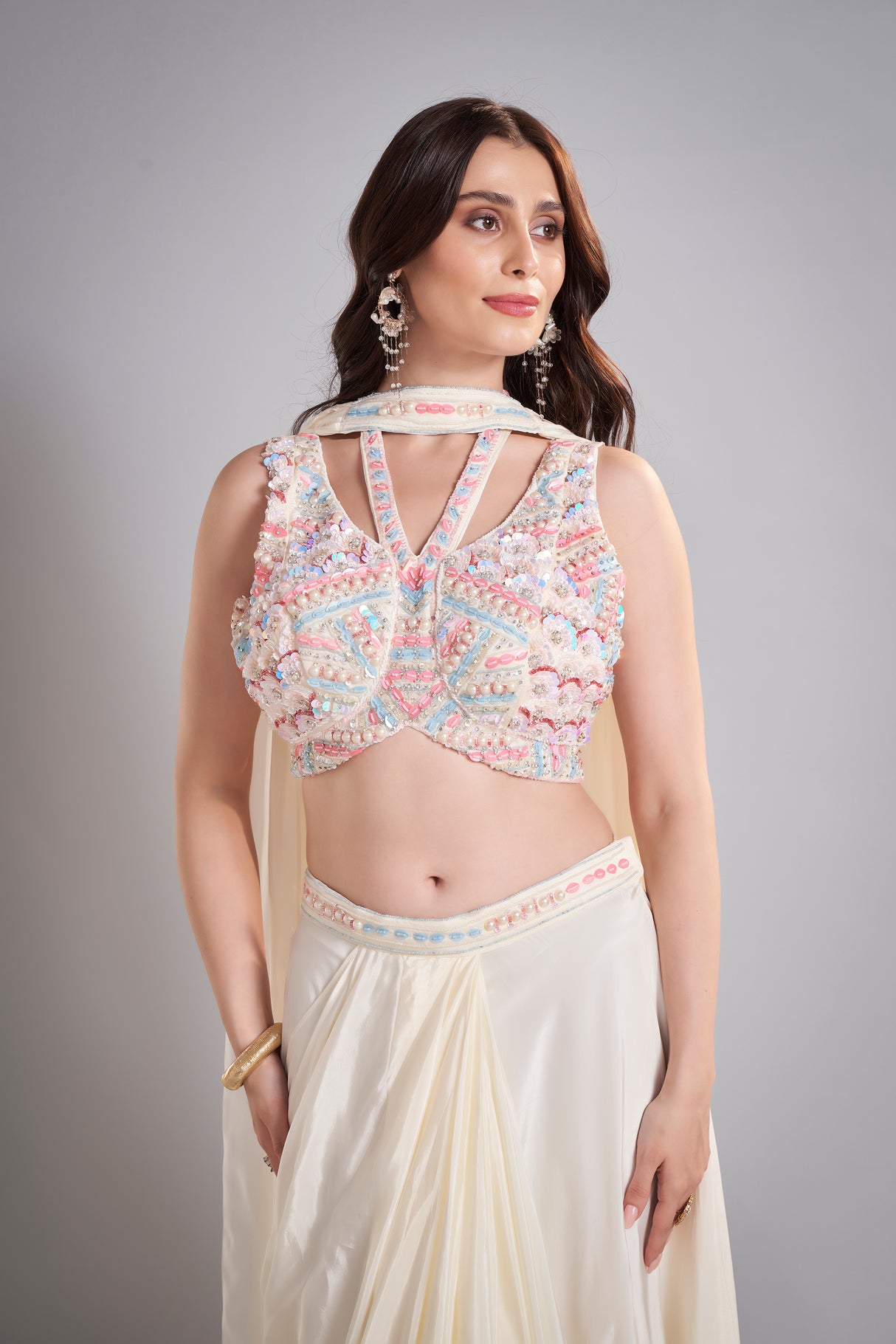 Ivory Draped Skirt with Pastel Embellished Crop Top & Flowing Drapes – Modern Wedding Reception Outfit