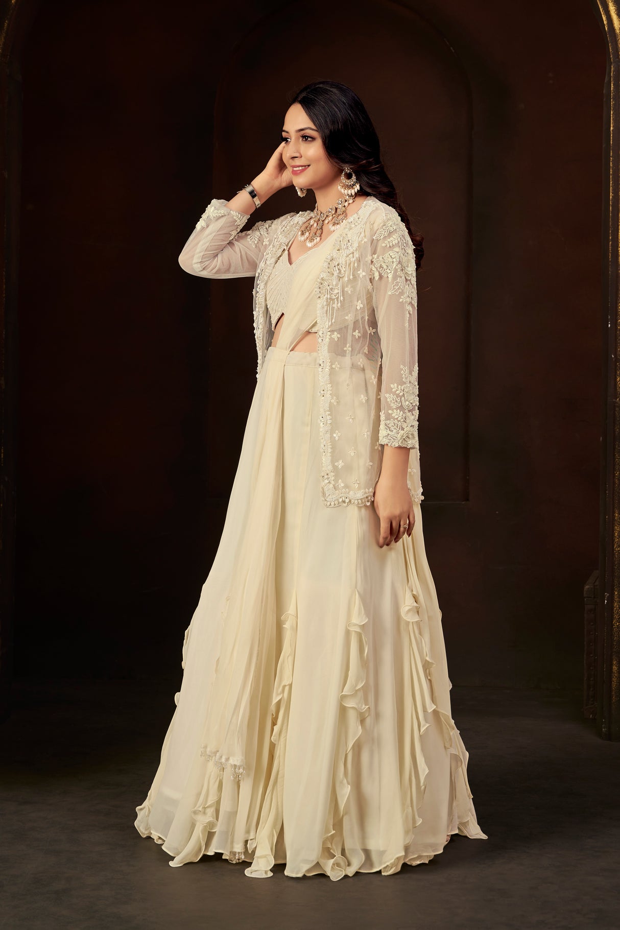 Ivory Ruffle Layered Georgette Lehenga Set with Embroidered Sheer Cape & Draped Corset Blouse – Minimalist Luxe Couture