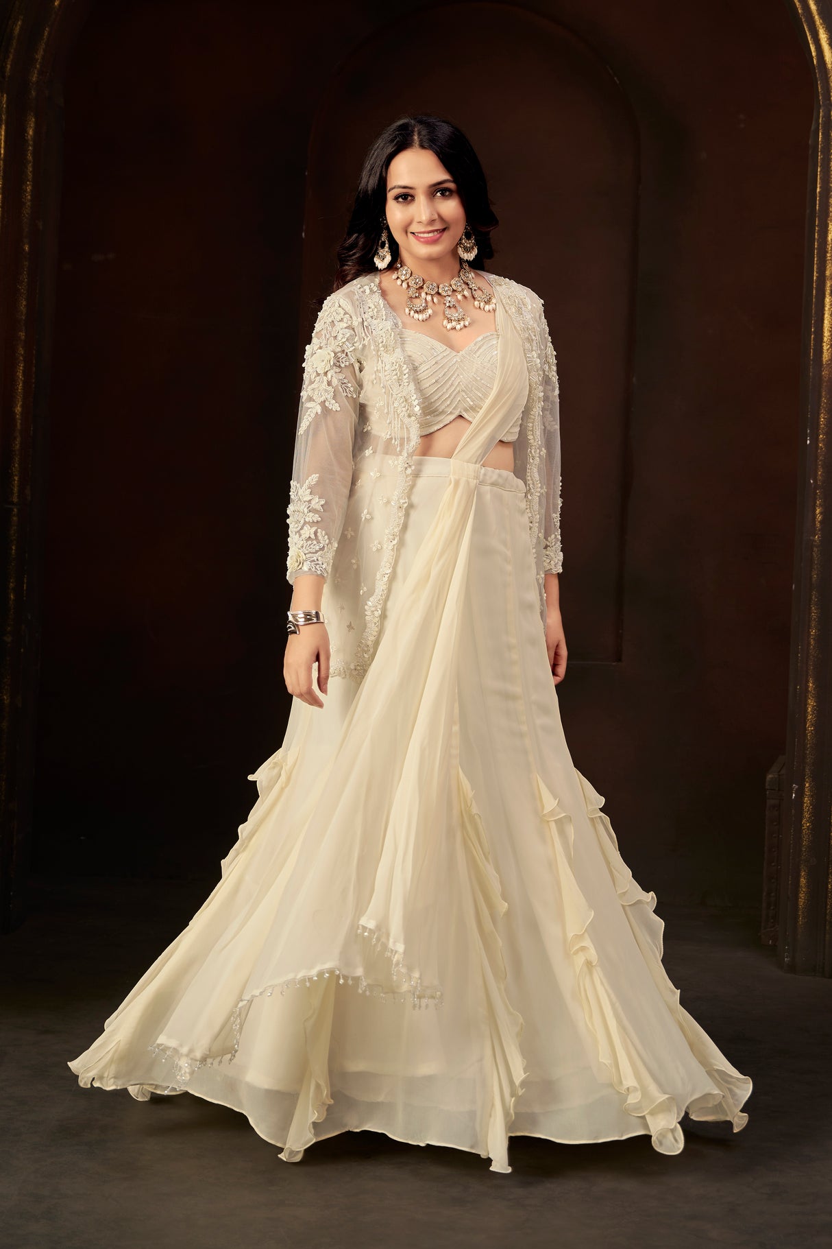 Ivory Ruffle Layered Georgette Lehenga Set with Embroidered Sheer Cape & Draped Corset Blouse – Minimalist Luxe Couture