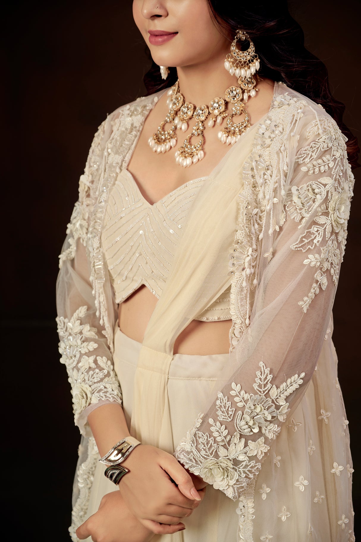Ivory Ruffle Layered Georgette Lehenga Set with Embroidered Sheer Cape & Draped Corset Blouse – Minimalist Luxe Couture