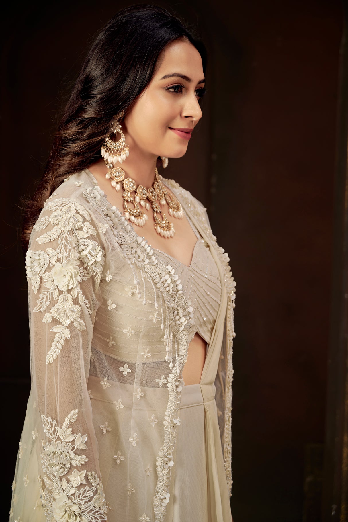 Ivory Ruffle Layered Georgette Lehenga Set with Embroidered Sheer Cape & Draped Corset Blouse – Minimalist Luxe Couture
