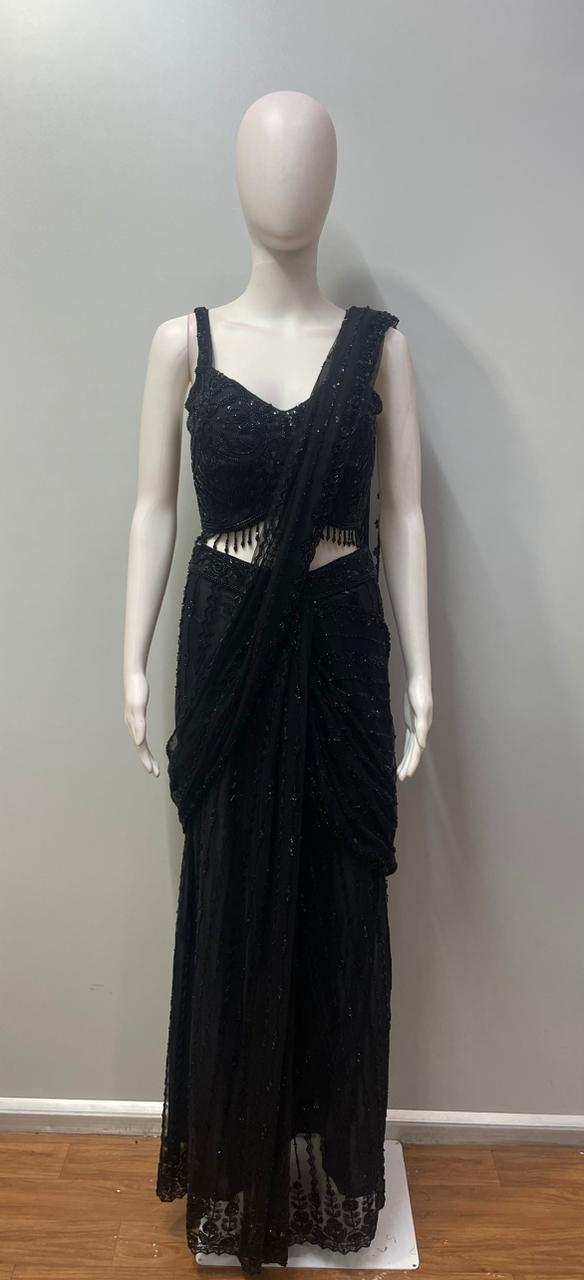 Full-length view of a black crystal draped skirt set on the model