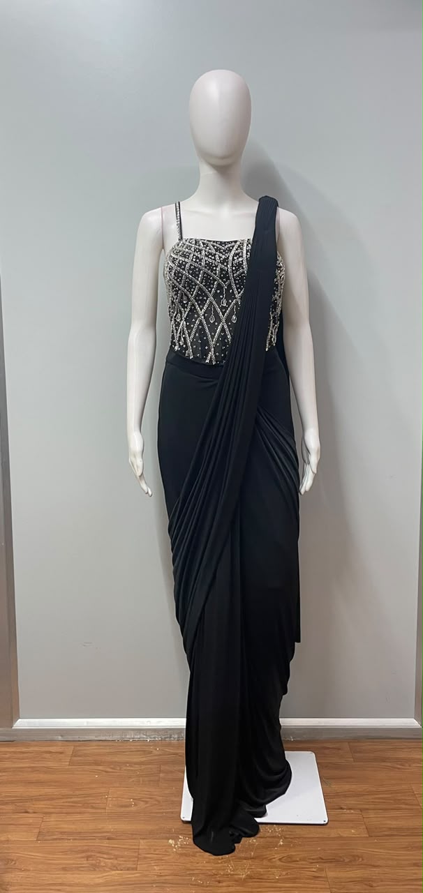 Close view of the silver embellishment on a black pre-draped saree