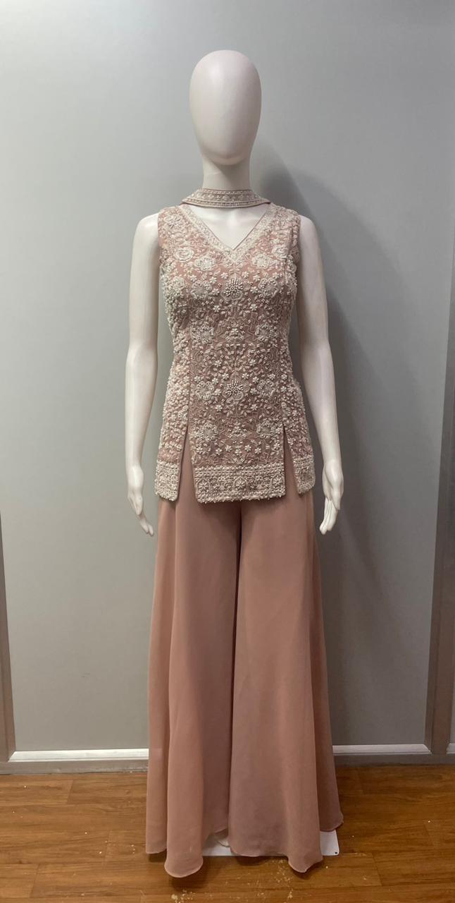 Full-length view of a dusty rose pearl jewel palazzo set on the model