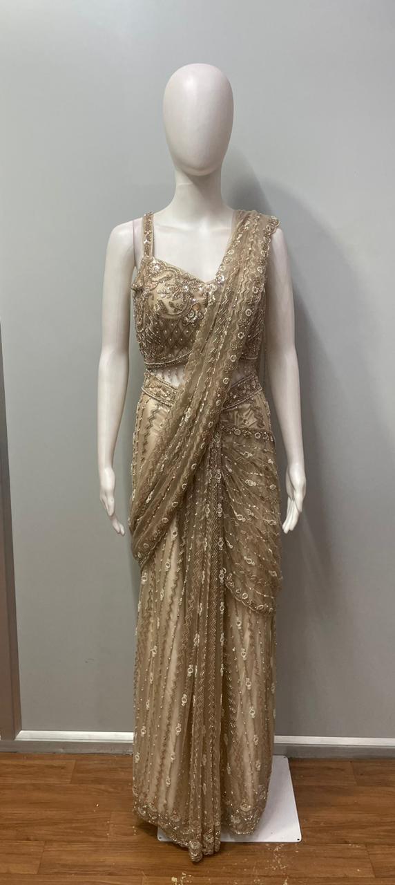 Full-length view of a champagne taupe crystal draped skirt set on the model