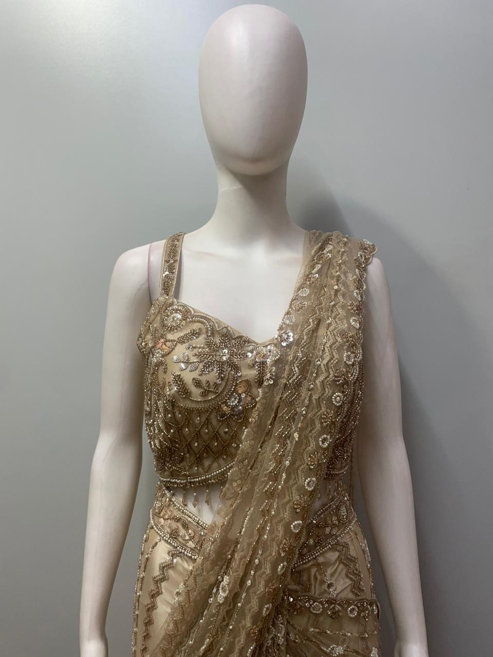 Close view of the beadwork and floral motifs on a champagne taupe blouse