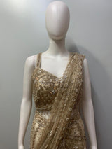 Close view of the beadwork and floral motifs on a champagne taupe blouse