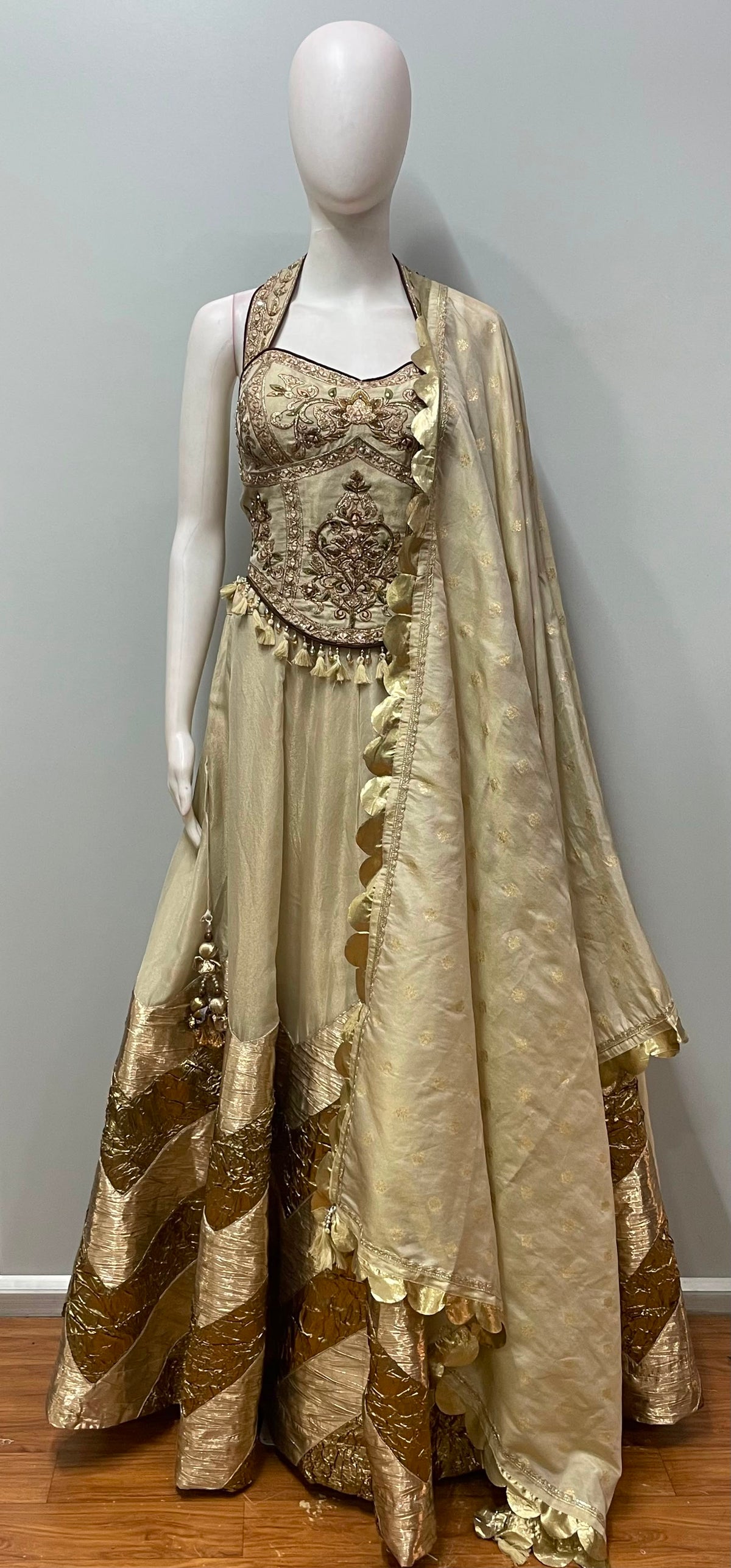 Close view of the gold embroidery on an ivory lehenga corset