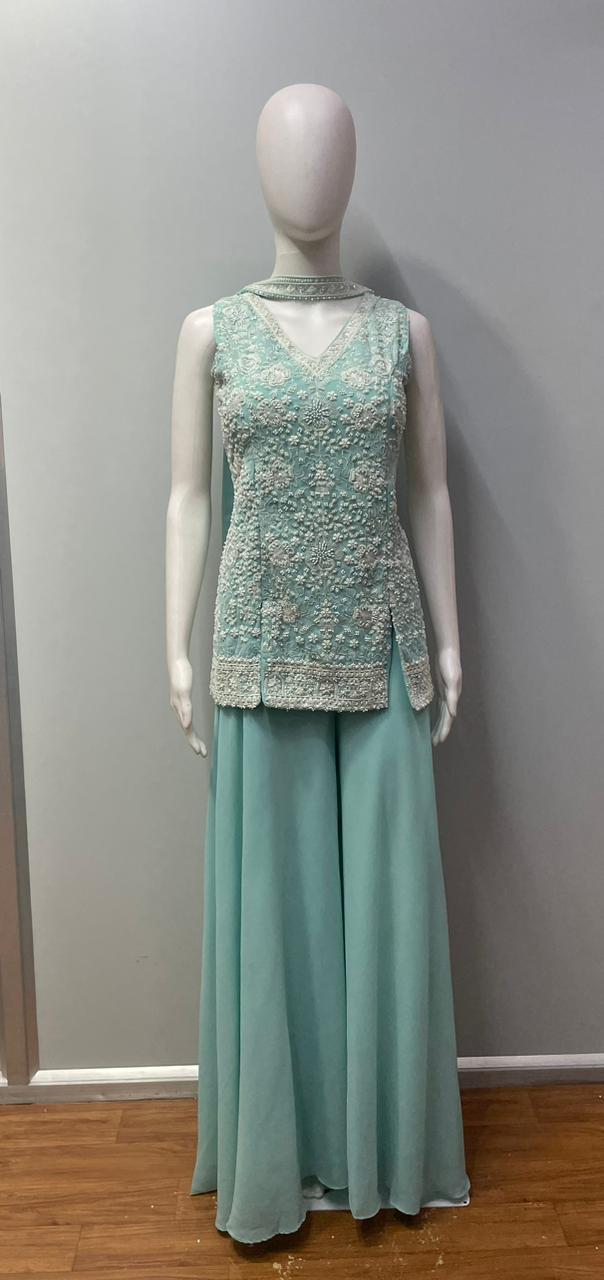 Full-length view of an aqua mint silver jewel palazzo set on the model