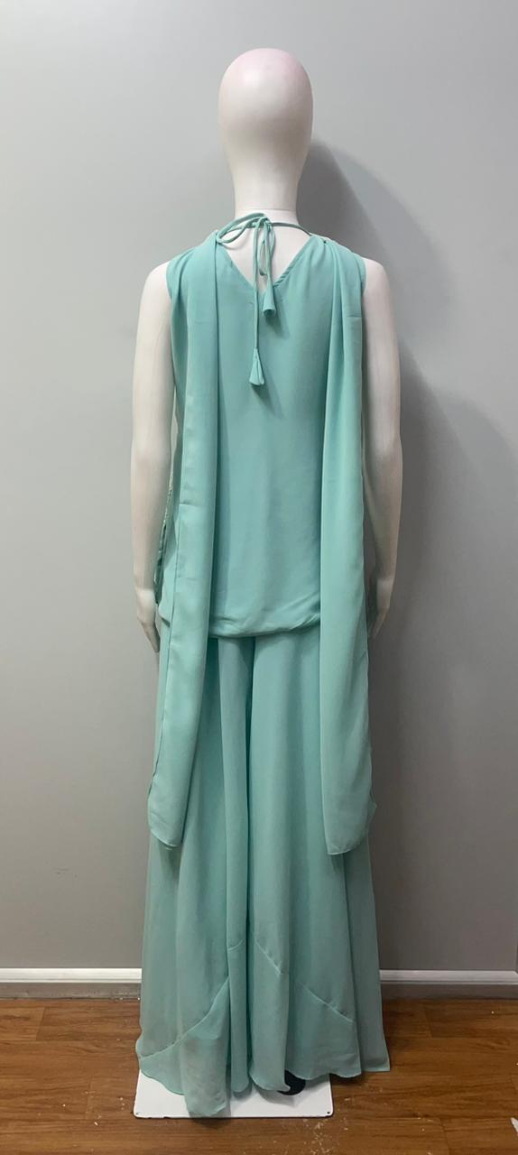 Side view showing the wide-leg fall of an aqua mint palazzo set
