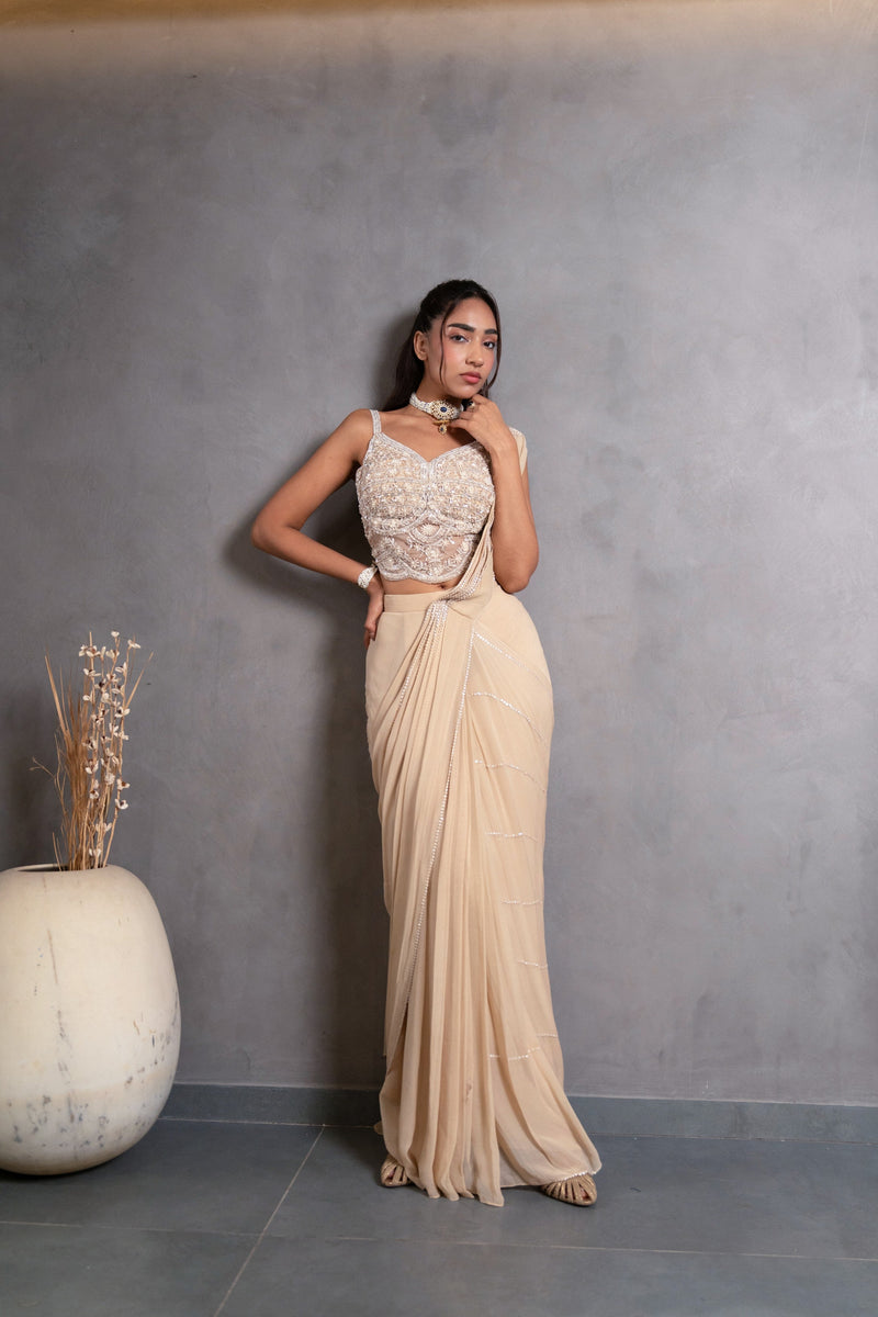 Detail of the pleated pallu on a champagne pearl draped saree
