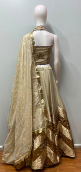 Detail of the skirt hem on an ivory gold corset lehenga ensemble