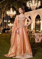 Peach corset lehenga with champagne gold jewel work and an ornate paisley hem border