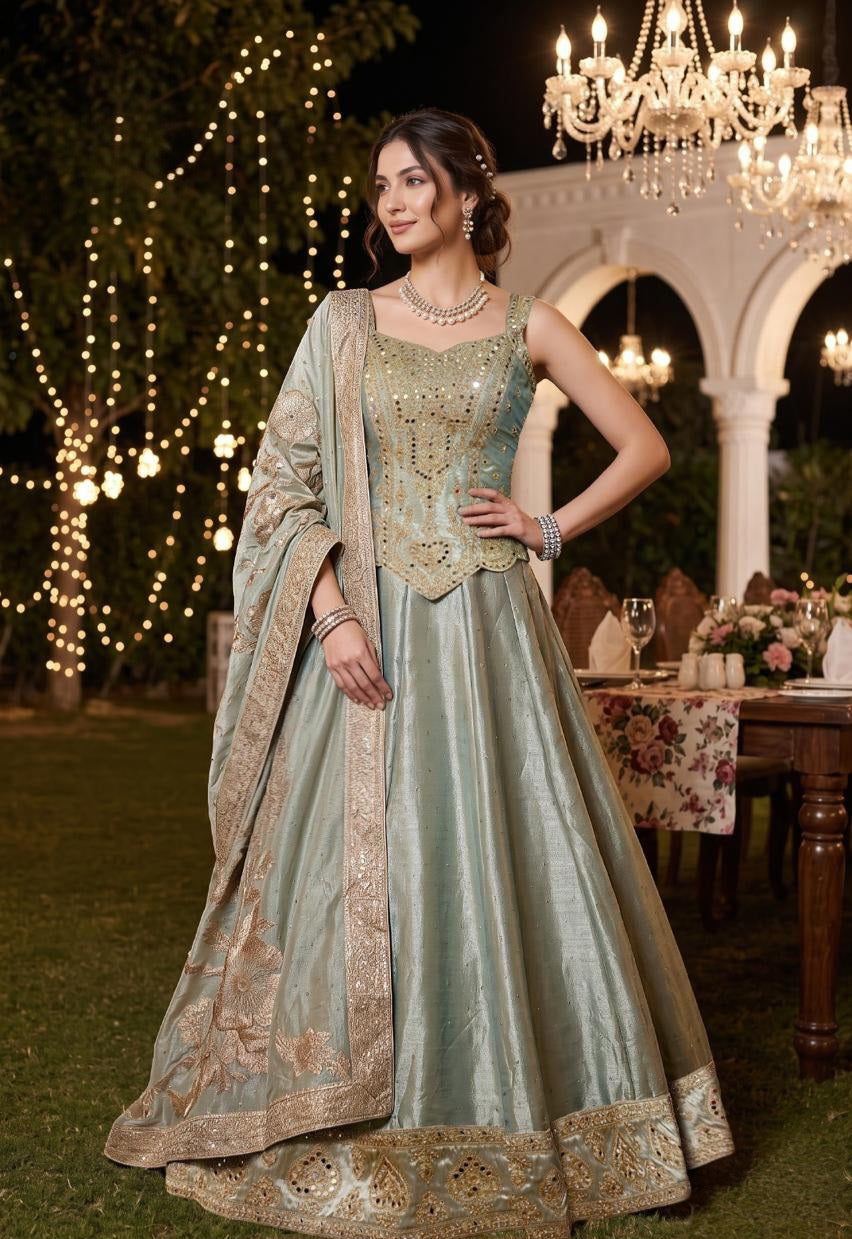 Seafoam green corset lehenga with antique gold beadwork and a floral bordered dupatta