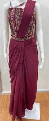 Close view of the embroidery on a wine coloured draped saree blouse