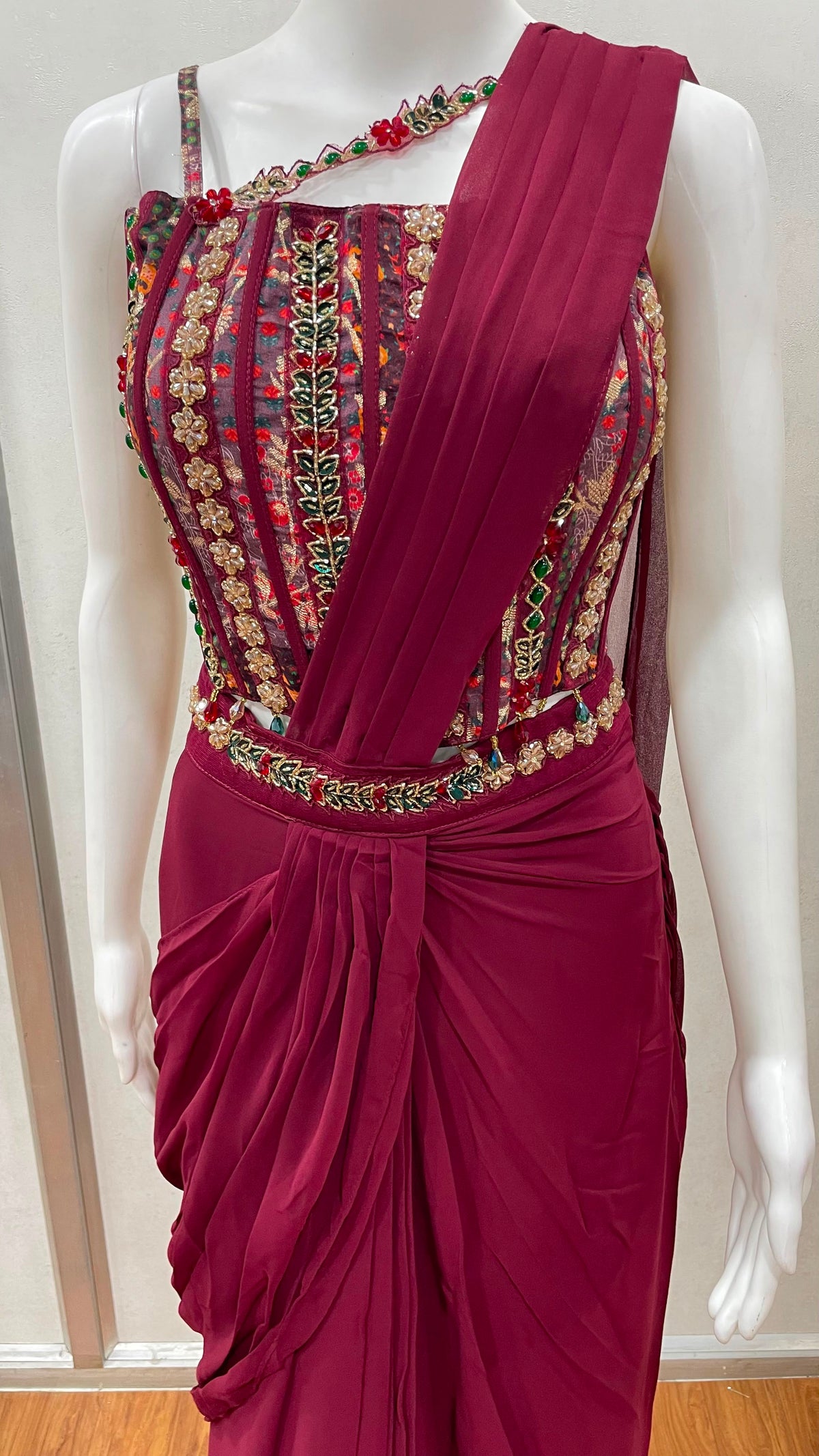 Full-length view of a wine embroidered draped saree couture set
