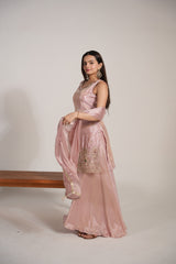 Close view of the embroidery on a blush pink sharara kurta and dupatta