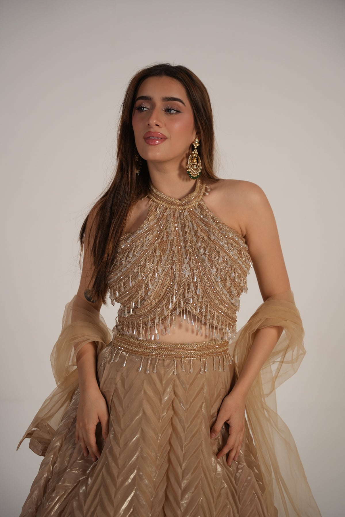 Close view of the shimmer fabric on a champagne halter lehenga