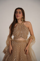 Close view of the shimmer fabric on a champagne halter lehenga