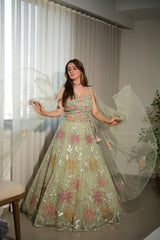Back view of a sage green floral net lehenga skirt and blouse