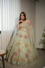 Sage net lehenga with floral work and a matching blouse and dupatta