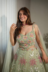 Full-length view of a sage floral net lehenga ensemble on the model