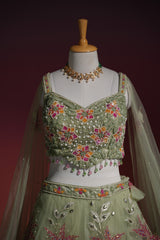 Detail of the dupatta edging on a sage floral net lehenga set