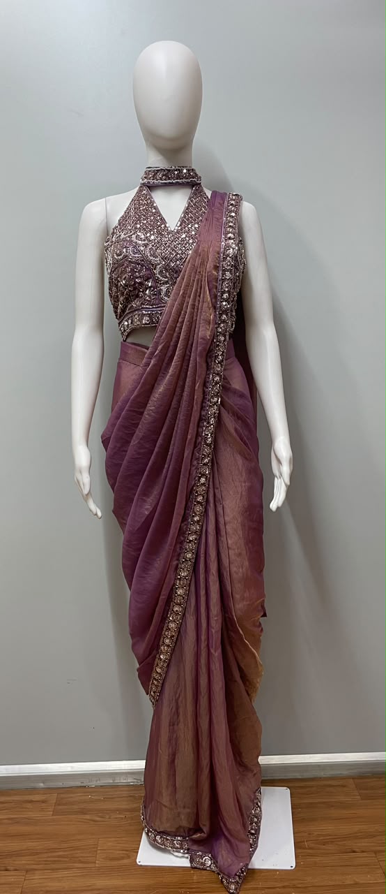 Close view of the embellishment on a mauve bronze draped saree