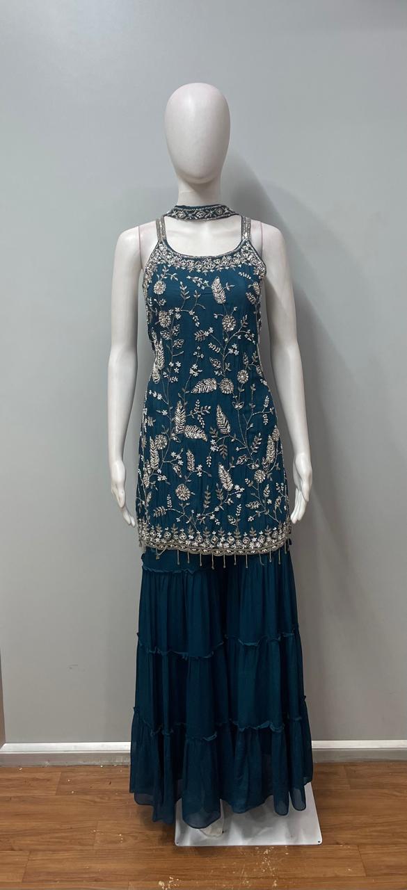 Full-length view of a teal embroidered layered sharara set on the model