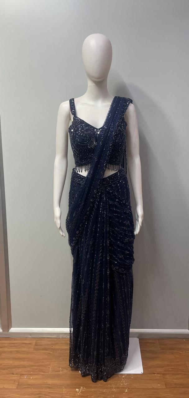 Full-length view of a midnight blue crystal draped skirt set on the model