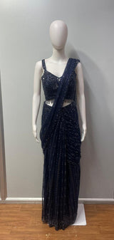 Full-length view of a midnight blue crystal draped skirt set on the model