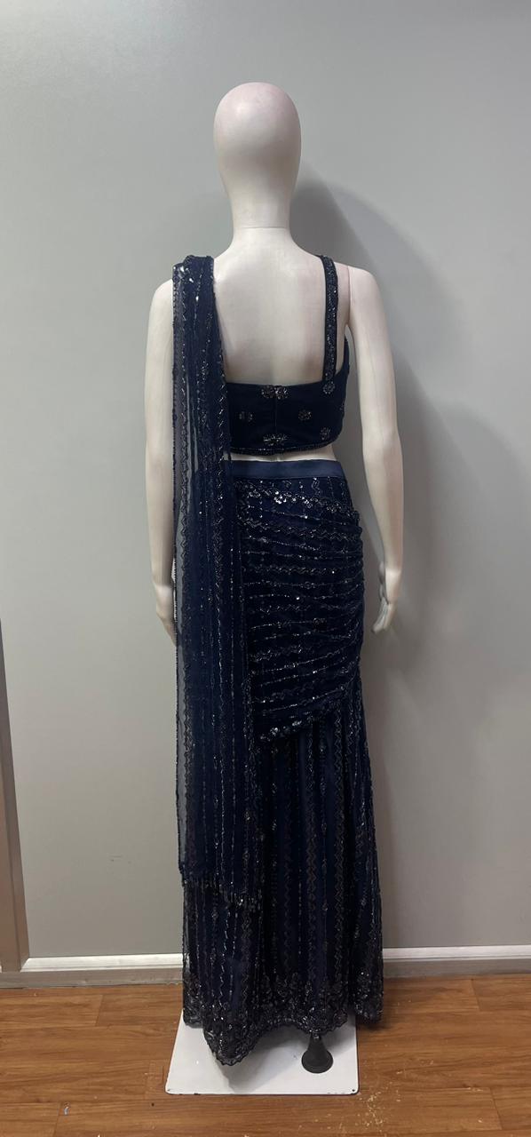 Side view showing the ruched waist and vertical folds of a midnight blue skirt