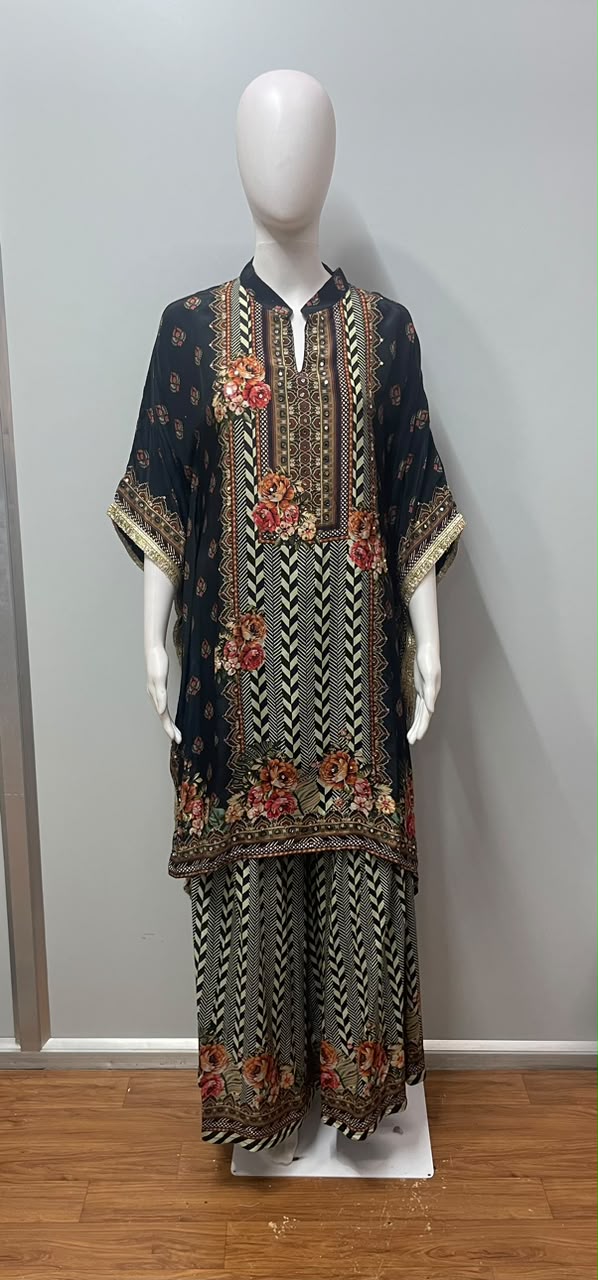 Sleeve and hem detail on a nomad print kaftan and trouser set
