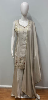 Close view of the gold work on an ivory sharara kurta and dupatta