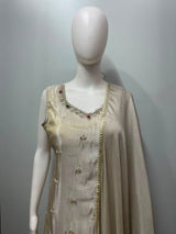 Full-length view of an ivory and gold sharara suit set on the model