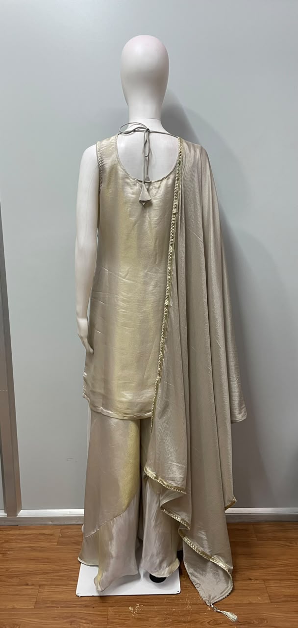Detail of the flared hem on an ivory and gold sharara suit set
