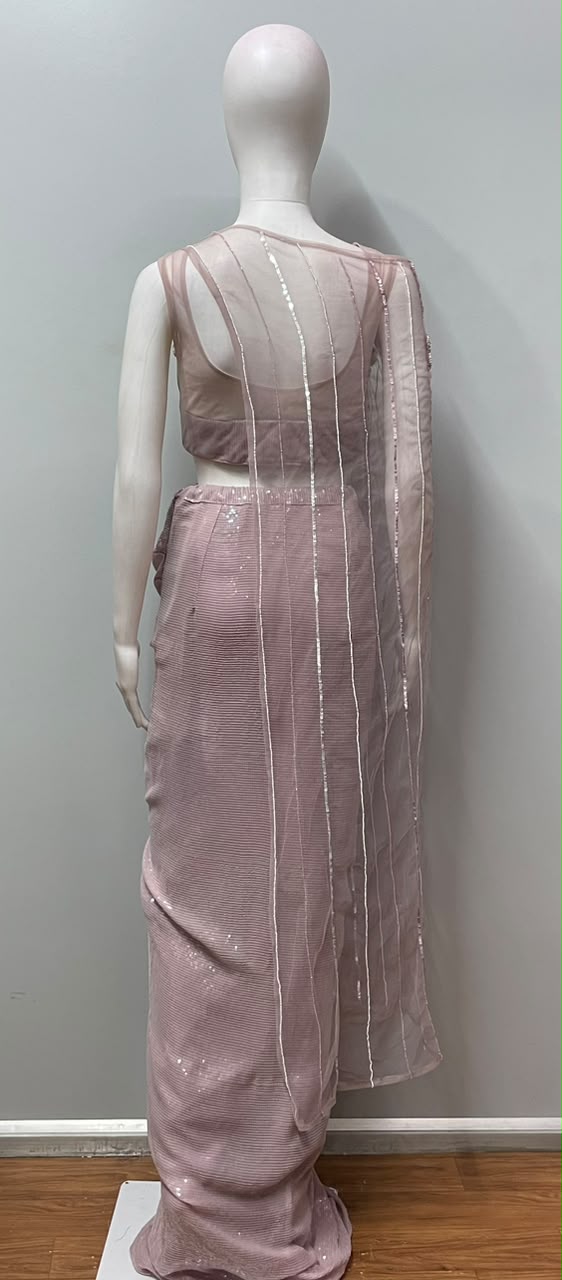 Detail of the sheer net cape on a lilac sequin draped skirt set