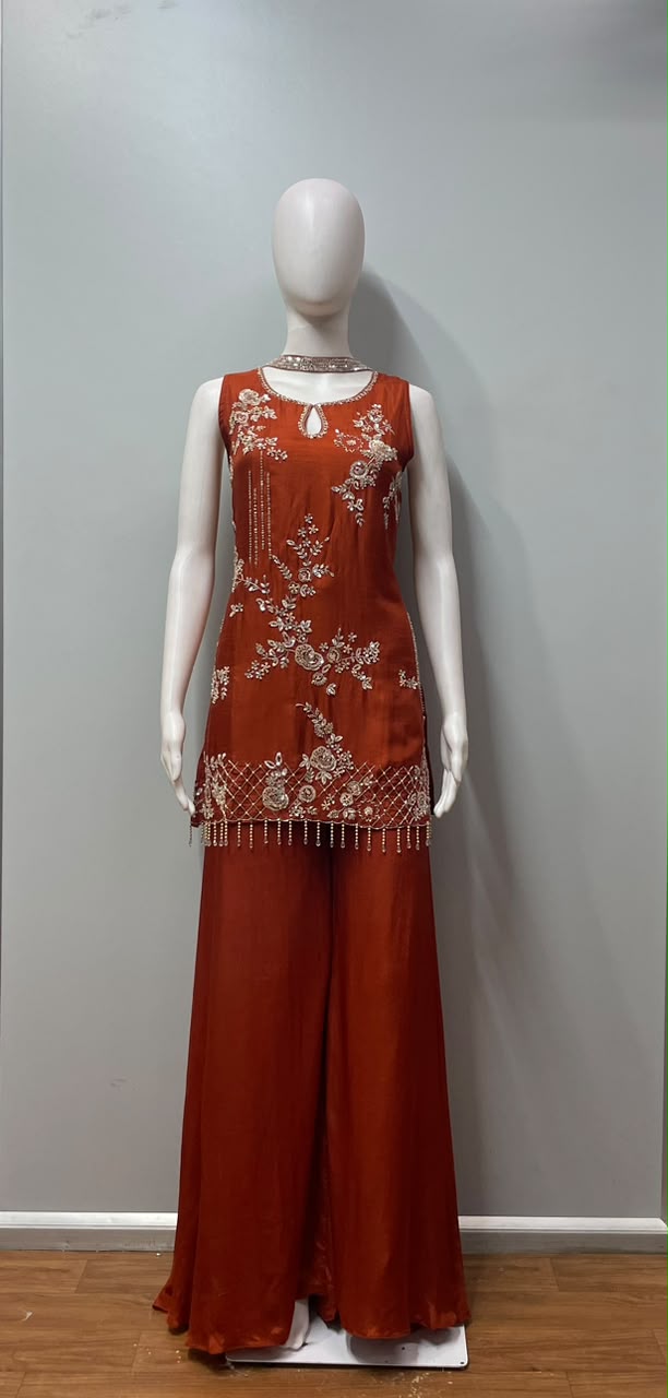 Full-length view of a burnt orange and gold embroidered palazzo set
