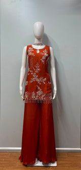 Full-length view of a burnt orange and gold embroidered palazzo set