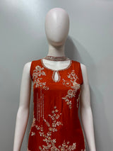 Detail of the neckline on a burnt orange gold embroidered kurta