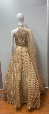 Hem detail on the skirt of a champagne shimmer halter lehenga