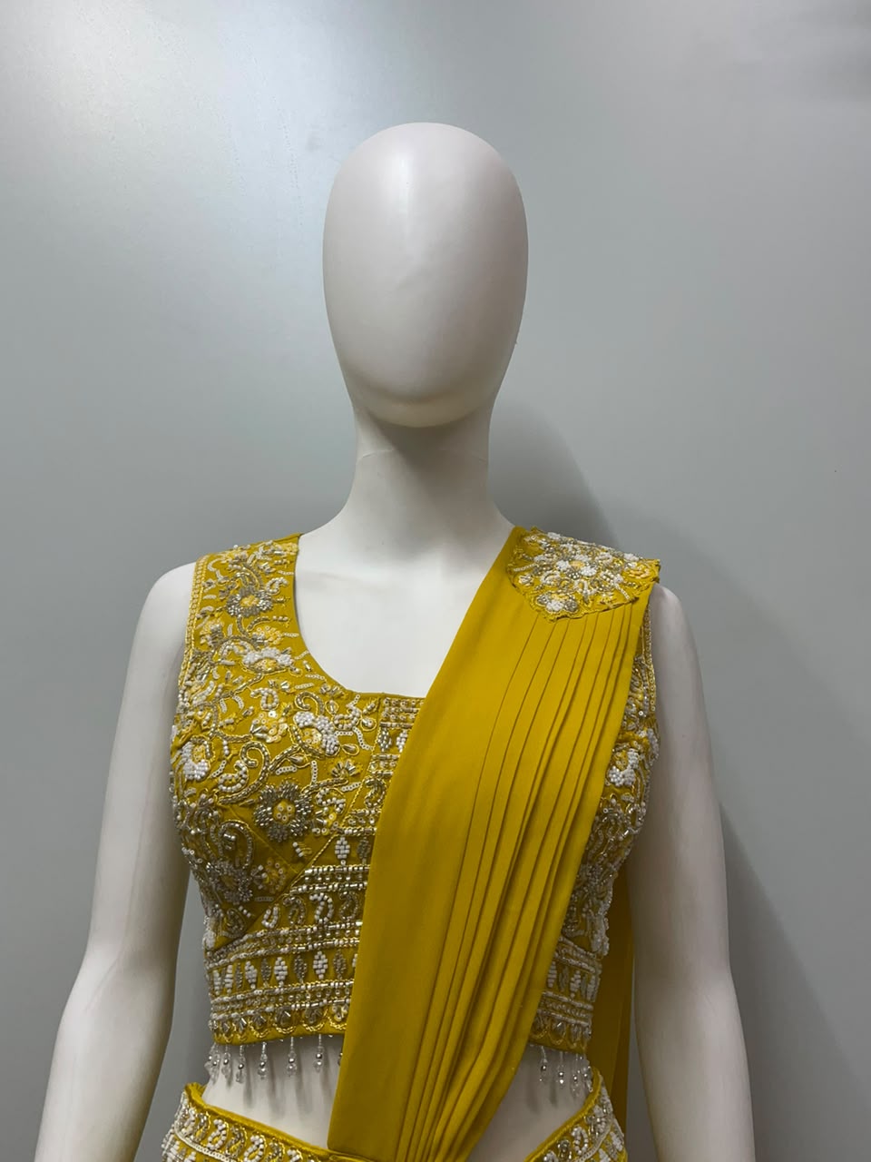 Full-length view of a golden luxe draped saree set on the model