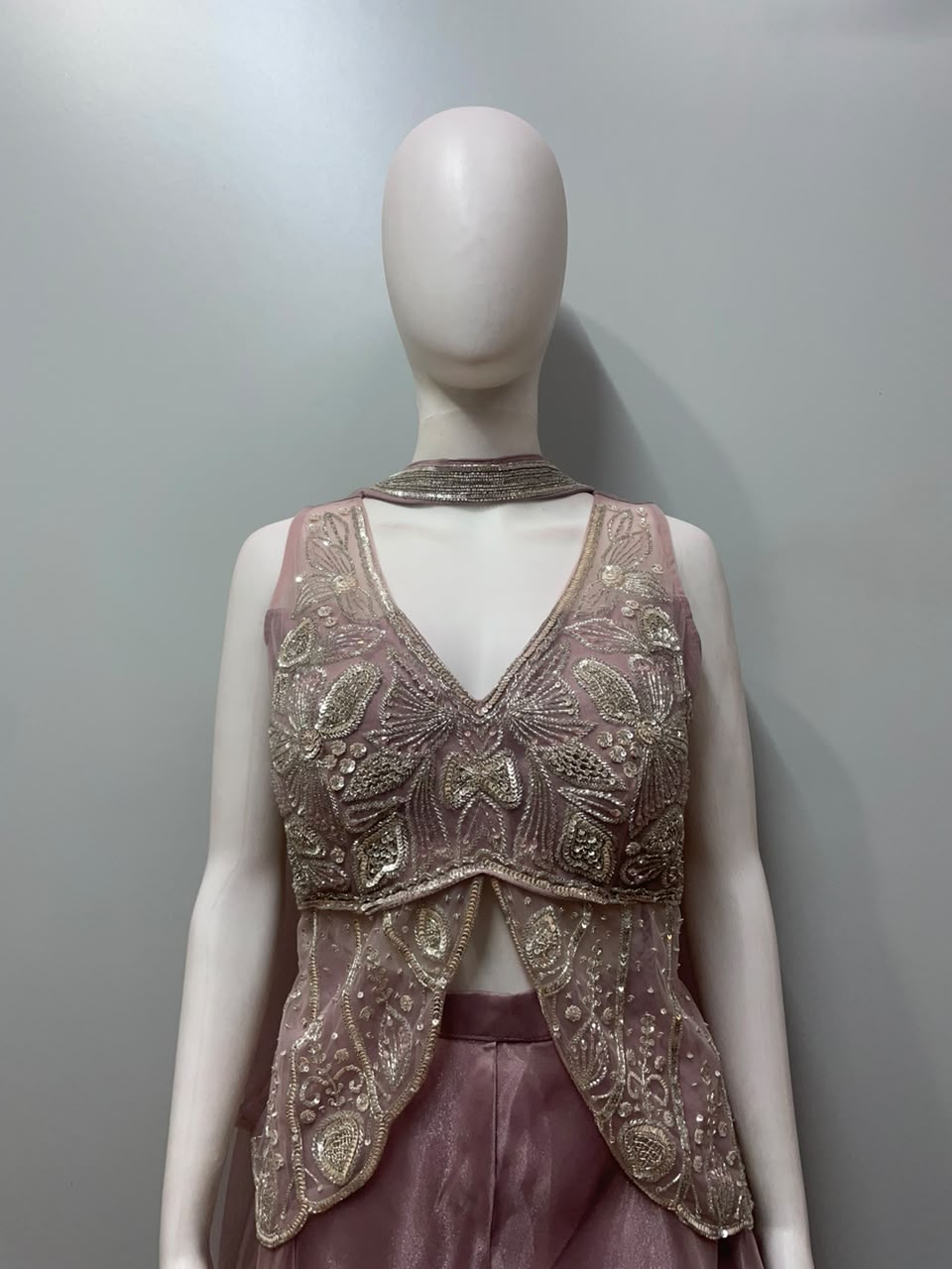 Close view of the embroidery on a dusty pink kurta and palazzo